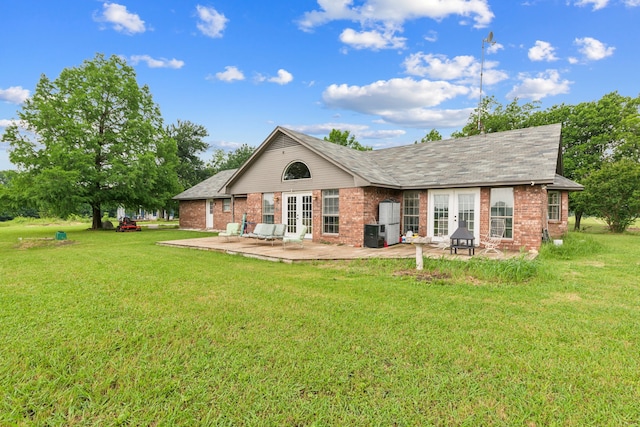 2227 Fm 2815 S, Bonham, TX 75418 - rear view of property with french doors, brick siding, a yard, and a patio area