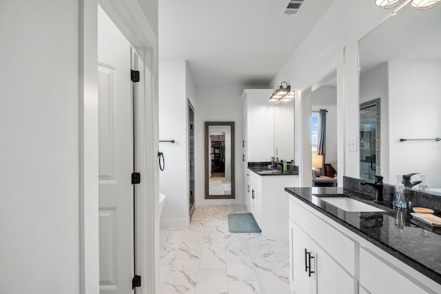 5185 Fox Trot Ln, Caddo Mills, TX 75135 - bathroom featuring marble look tiles, two vanities, a freestanding bath, and a stall shower
