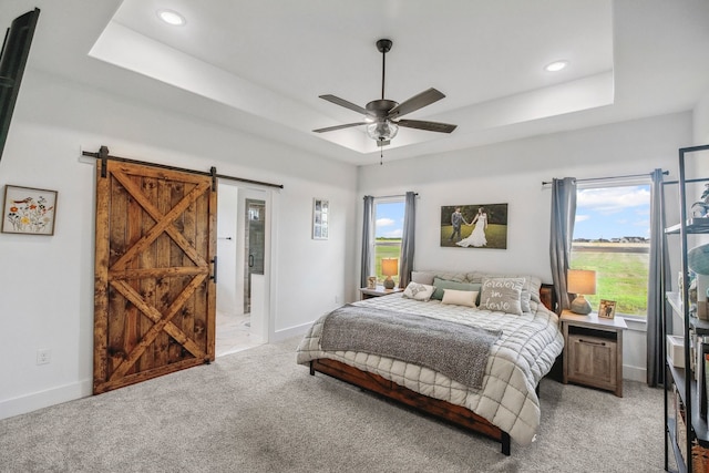 5185 Fox Trot Ln, Caddo Mills, TX 75135 - bedroom with a tray ceiling, a barn door, light carpet, recessed lighting, and baseboards