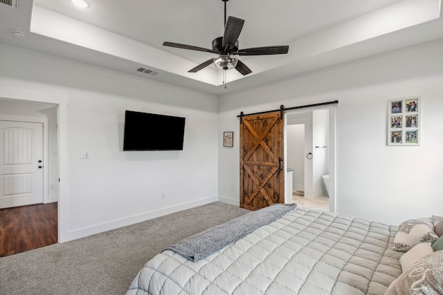 5185 Fox Trot Ln, Caddo Mills, TX 75135 - carpeted bedroom with a barn door, baseboards, a raised ceiling, ceiling fan, and connected bathroom