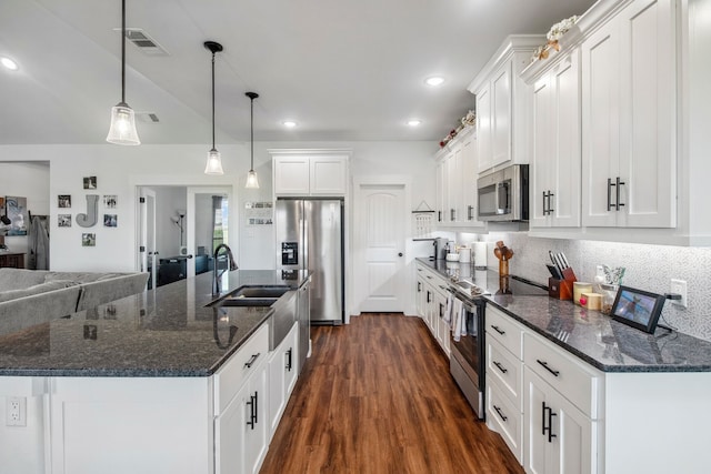5185 Fox Trot Ln, Caddo Mills, TX 75135 - kitchen featuring stainless steel appliances, white cabinets, dark wood-style flooring, a sink, and recessed lighting