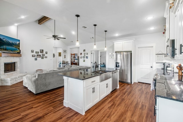 5185 Fox Trot Ln, Caddo Mills, TX 75135 - kitchen featuring stainless steel appliances, open floor plan, beam ceiling, a fireplace, and dark wood-type flooring