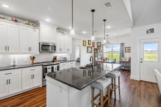 5185 Fox Trot Ln, Caddo Mills, TX 75135 - kitchen with appliances with stainless steel finishes, a sink, recessed lighting, white cabinetry, and dark wood-style floors