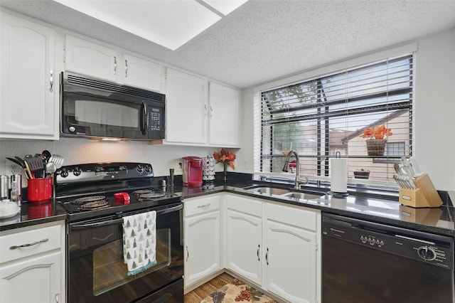 5590 Spring Valley Rd Unit C208, Dallas, TX 75254 - kitchen with black appliances, a sink, dark countertops, white cabinetry, and a textured ceiling