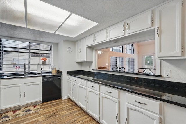 5590 Spring Valley Rd Unit C208, Dallas, TX 75254 - kitchen with dishwasher, a sink, white cabinets, and a textured ceiling