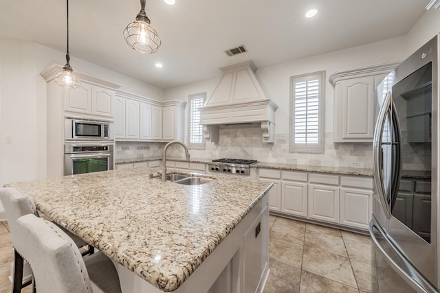 2117 Torin St, Lewisville, TX 75056 - kitchen with appliances with stainless steel finishes, a sink, premium range hood, backsplash, and recessed lighting