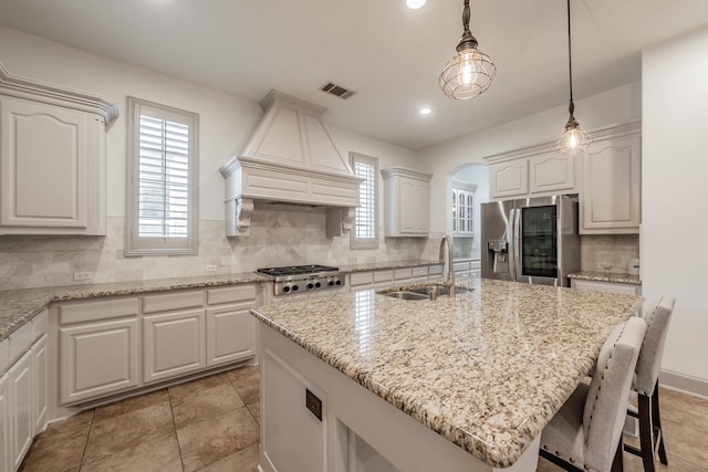 2117 Torin St, Lewisville, TX 75056 - kitchen featuring stainless steel appliances, a sink, premium range hood, decorative backsplash, and recessed lighting
