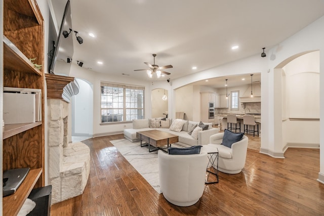 2117 Torin St, Lewisville, TX 75056 - living area with arched walkways, a ceiling fan, wood-type flooring, healthy amount of natural light, and recessed lighting