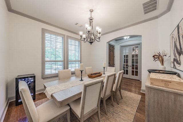 2117 Torin St, Lewisville, TX 75056 - dining space with arched walkways, a chandelier, ornamental molding, dark wood finished floors, and french doors
