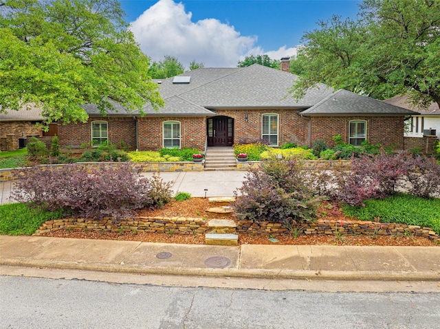 15810 Ranchita Dr, Dallas, TX 75248 - traditional home with a chimney, roof with shingles, and brick siding
