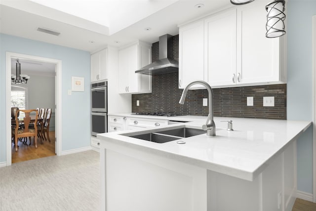 15810 Ranchita Dr, Dallas, TX 75248 - kitchen with wall chimney exhaust hood, stainless steel double oven, backsplash, baseboards, and recessed lighting