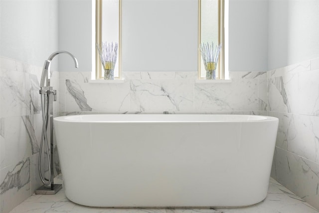 15810 Ranchita Dr, Dallas, TX 75248 - full bath with tile walls, plenty of natural light, wainscoting, marble finish flooring, and a freestanding tub