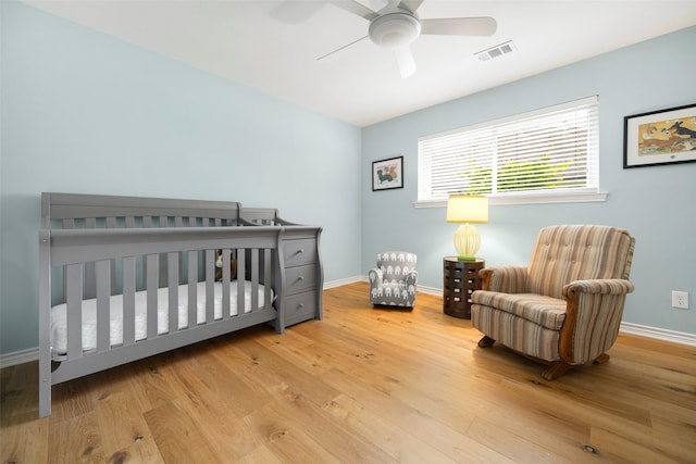 15810 Ranchita Dr, Dallas, TX 75248 - bedroom with wood finished floors, baseboards, a crib, and ceiling fan