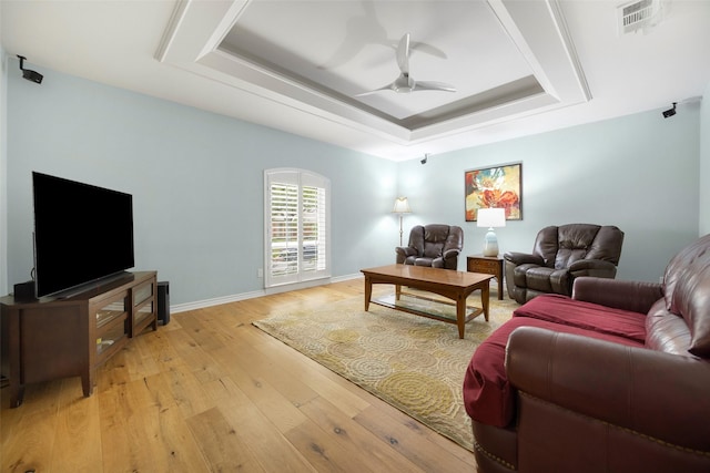 15810 Ranchita Dr, Dallas, TX 75248 - living area with a raised ceiling, a ceiling fan, light wood-type flooring, and baseboards