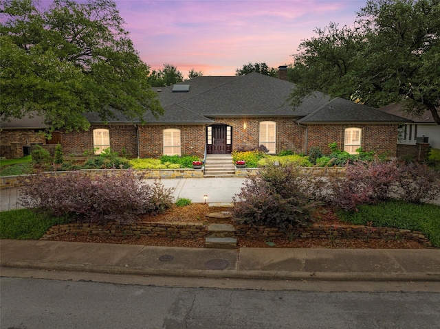 15810 Ranchita Dr, Dallas, TX 75248 - view of front of house with a chimney, a shingled roof, and brick siding