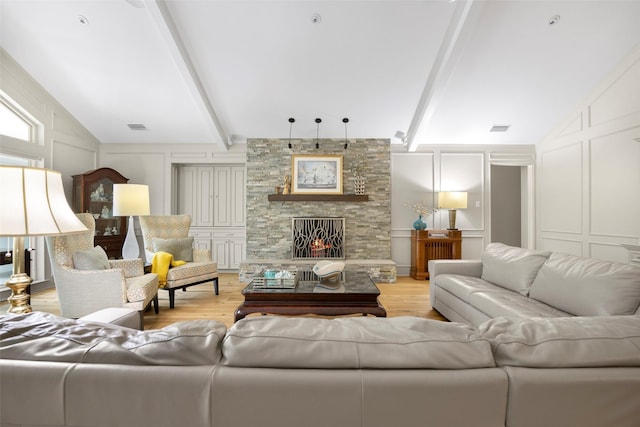 15810 Ranchita Dr, Dallas, TX 75248 - living area with a decorative wall, light wood-style floors, and a stone fireplace