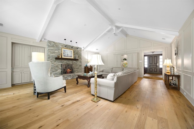 15810 Ranchita Dr, Dallas, TX 75248 - living room featuring a decorative wall, light wood finished floors, and a stone fireplace