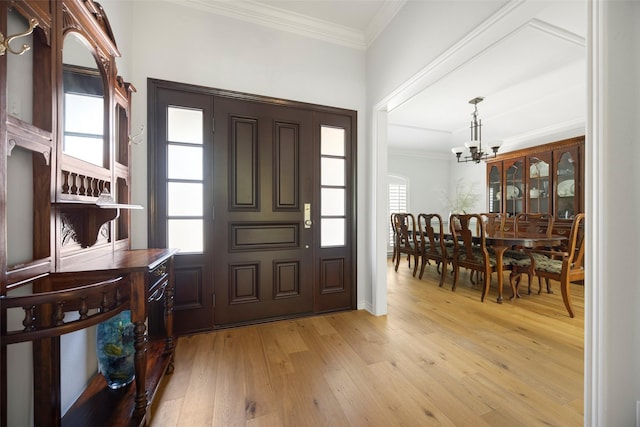 15810 Ranchita Dr, Dallas, TX 75248 - foyer with light wood finished floors, a chandelier, crown molding, and baseboards