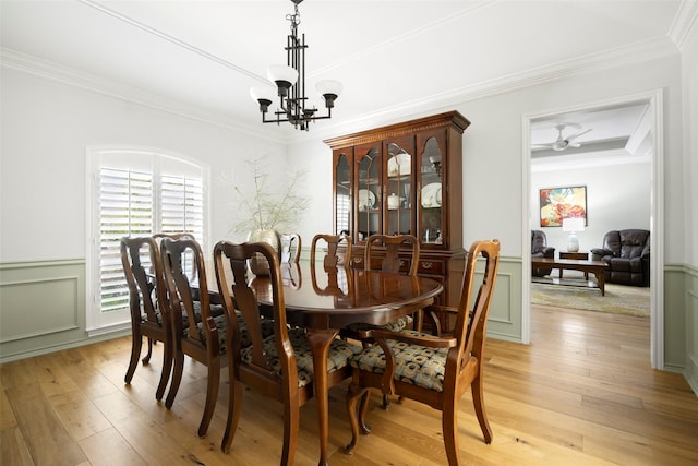 15810 Ranchita Dr, Dallas, TX 75248 - dining area featuring light wood-style floors, a chandelier, wainscoting, ornamental molding, and a decorative wall