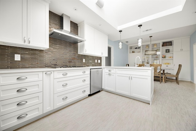 15810 Ranchita Dr, Dallas, TX 75248 - kitchen featuring wall chimney exhaust hood, cooktop, stainless steel dishwasher, a peninsula, and white cabinets