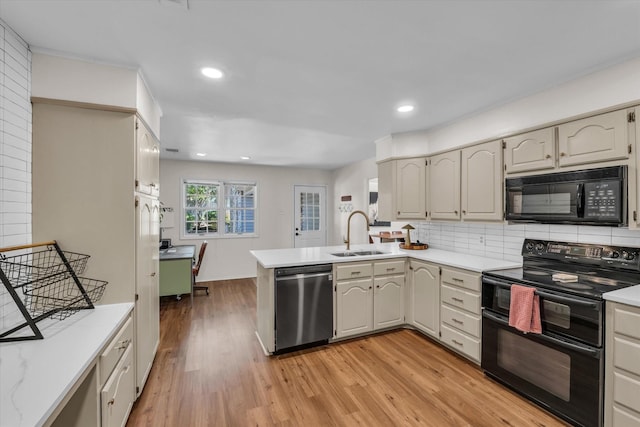 13734 Riverview Dr, Woodway, TX 76712 - kitchen featuring black appliances, a sink, a peninsula, light countertops, and light wood finished floors