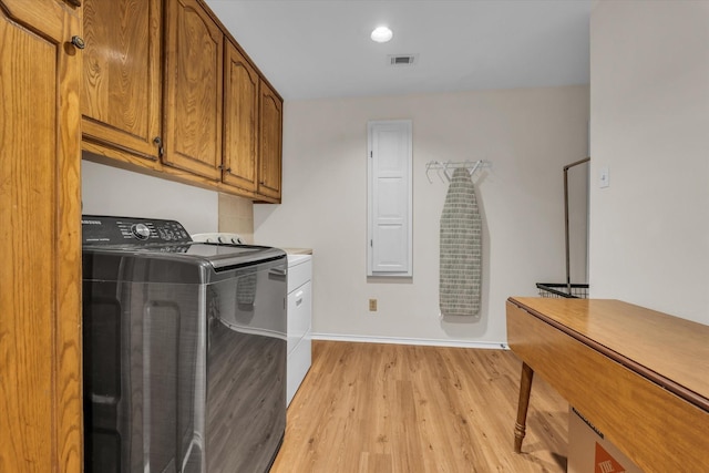 13734 Riverview Dr, Woodway, TX 76712 - laundry area with cabinet space, washing machine and dryer, light wood finished floors, and baseboards