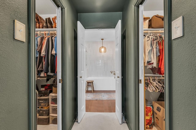 13734 Riverview Dr, Woodway, TX 76712 - corridor featuring light tile patterned floors and a textured wall