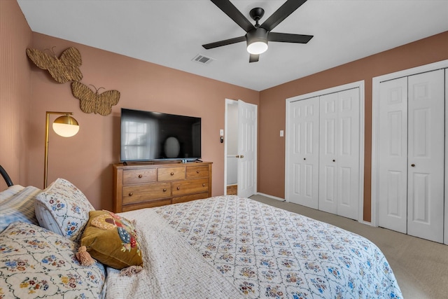 13734 Riverview Dr, Woodway, TX 76712 - carpeted bedroom with two closets, a ceiling fan, and baseboards
