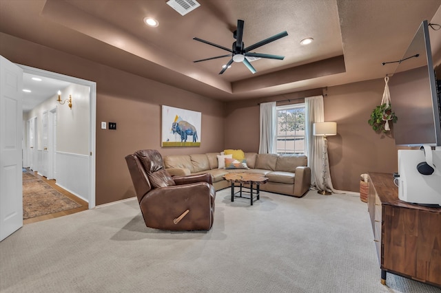 13734 Riverview Dr, Woodway, TX 76712 - living area with ceiling fan, a raised ceiling, baseboards, light colored carpet, and recessed lighting