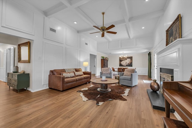 13734 Riverview Dr, Woodway, TX 76712 - living area featuring a decorative wall, coffered ceiling, a ceiling fan, light wood-type flooring, and beam ceiling