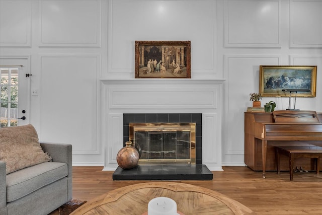 13734 Riverview Dr, Woodway, TX 76712 - detailed view of a decorative wall, wood finished floors, and a tiled fireplace