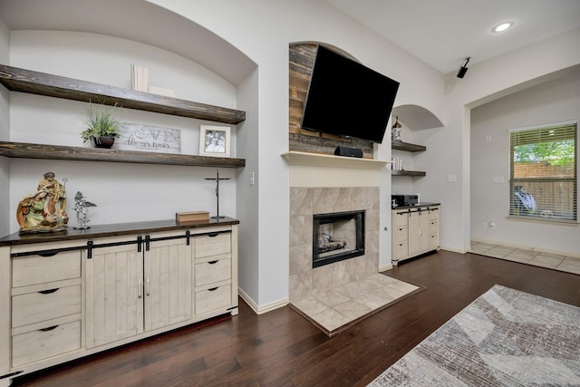 3532 Gallant Trl, Fort Worth, TX 76244 - living area featuring a tiled fireplace, recessed lighting, dark wood-style flooring, and baseboards