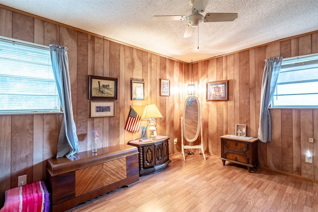1361 Shady Ln, Canton, TX 75103 - home office featuring a ceiling fan, a textured ceiling, wood finished floors, and wood walls