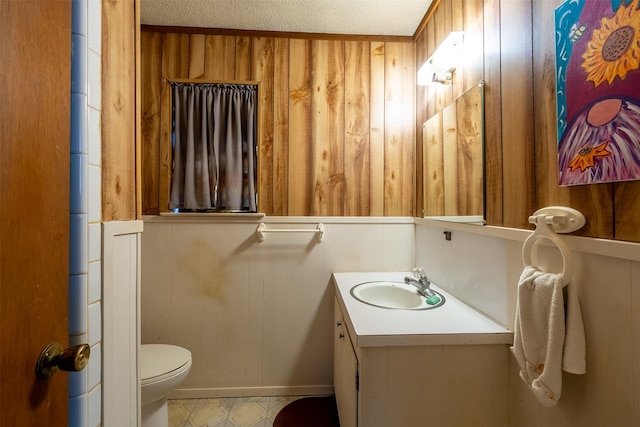 1361 Shady Ln, Canton, TX 75103 - half bathroom with toilet, vanity, wooden walls, and baseboards