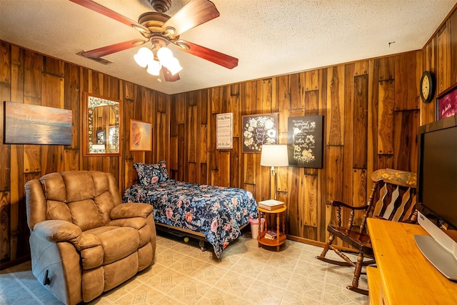 1361 Shady Ln, Canton, TX 75103 - bedroom featuring wooden walls, a textured ceiling, and ceiling fan
