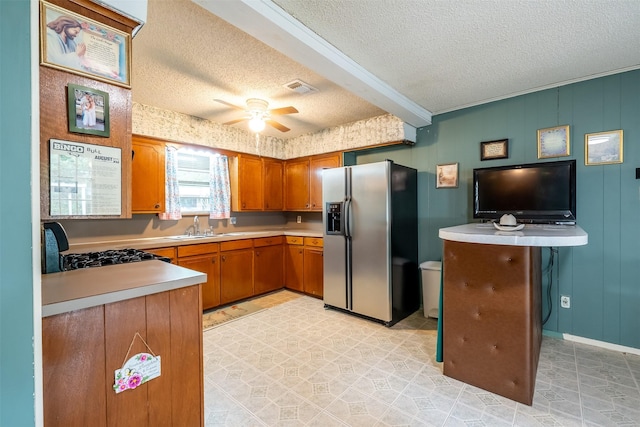 1361 Shady Ln, Canton, TX 75103 - kitchen with stainless steel fridge with ice dispenser, light countertops, a textured ceiling, brown cabinetry, and ceiling fan