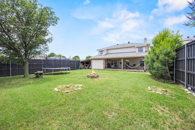 2701 Peach Dr, Little Elm, TX 75068 - view of yard with a trampoline, a fire pit, and a patio