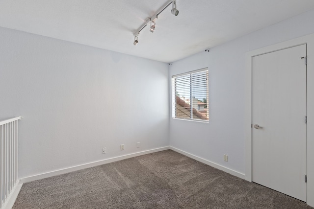 4777 Cedar Springs Rd Unit 6N, Dallas, TX 75219 - carpeted empty room featuring baseboards and rail lighting