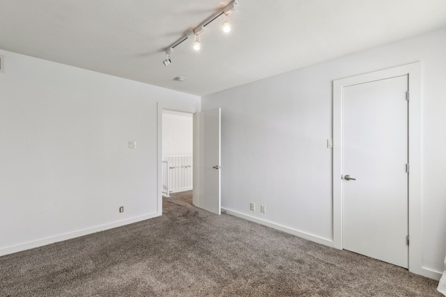 4777 Cedar Springs Rd Unit 6N, Dallas, TX 75219 - spare room featuring carpet floors, rail lighting, and baseboards