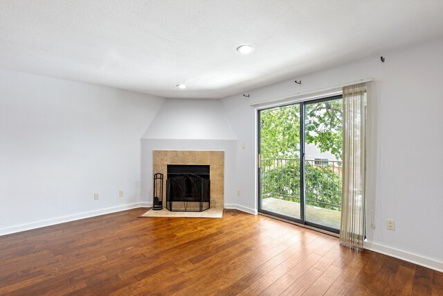 4777 Cedar Springs Rd Unit 6N, Dallas, TX 75219 - unfurnished living room featuring hardwood / wood-style floors, a fireplace, baseboards, and recessed lighting