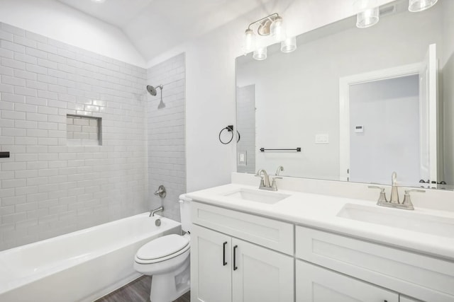 1005 Springfield Dr, Springtown, TX 76082 - full bath featuring double vanity, toilet, tub / shower combination, wood finished floors, and vaulted ceiling
