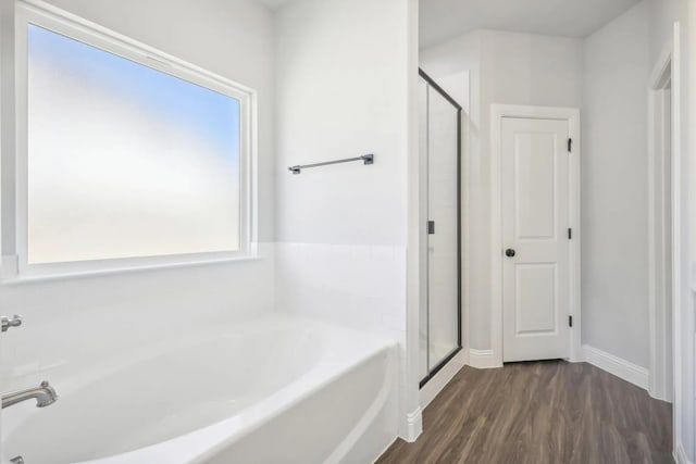1005 Springfield Dr, Springtown, TX 76082 - full bathroom with a garden tub, a shower stall, wood finished floors, and baseboards