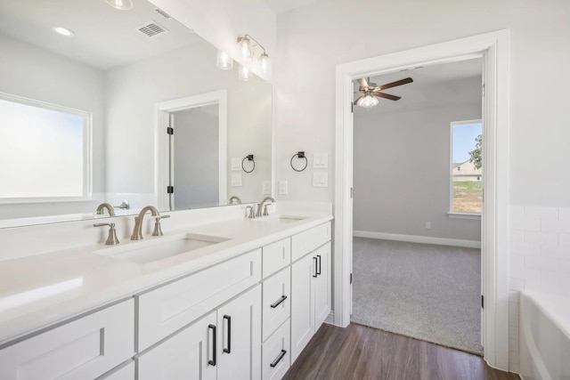 1005 Springfield Dr, Springtown, TX 76082 - full bath featuring double vanity, ceiling fan, a bathtub, wood finished floors, and baseboards
