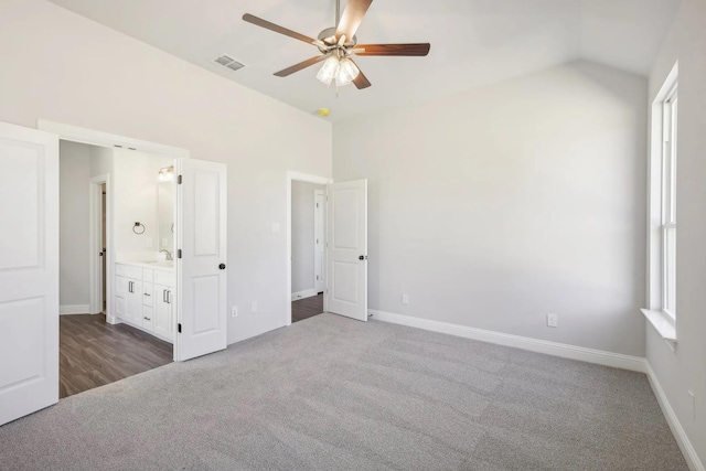 1005 Springfield Dr, Springtown, TX 76082 - unfurnished bedroom with carpet floors, lofted ceiling, baseboards, connected bathroom, and a sink