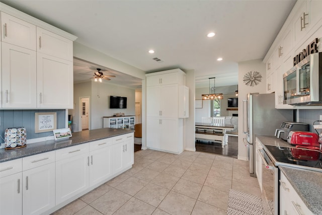 15393 Armstrong Rd, Terrell, TX 75160 - kitchen featuring stainless steel microwave, white electric range, white cabinetry, recessed lighting, and a ceiling fan