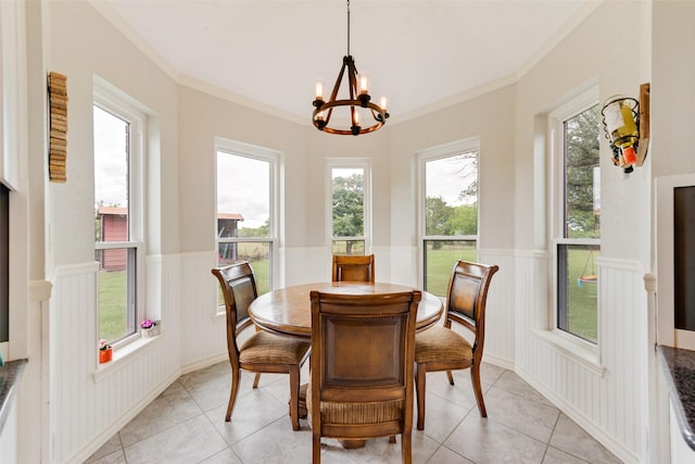 15393 Armstrong Rd, Terrell, TX 75160 - dining area with wainscoting, a chandelier, light tile patterned floors, ornamental molding, and a decorative wall