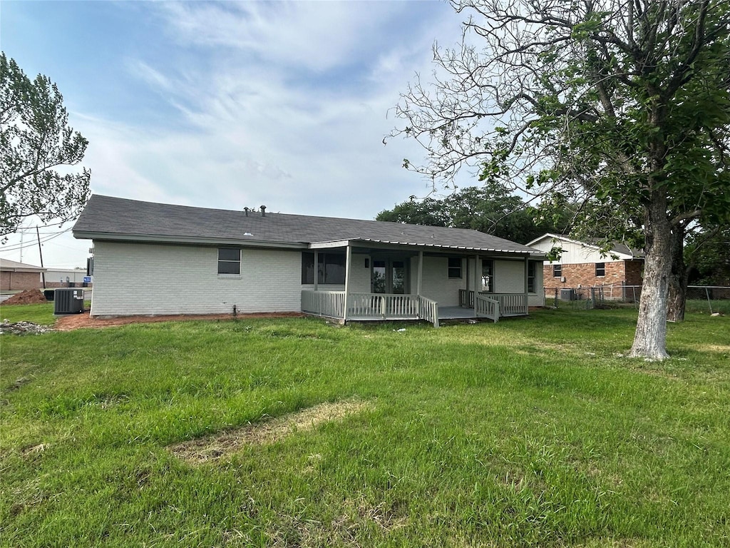 417 W Lyndale Ave, Robinson, TX 76706 - back of house featuring central air condition unit, brick siding, roof with shingles, and a porch