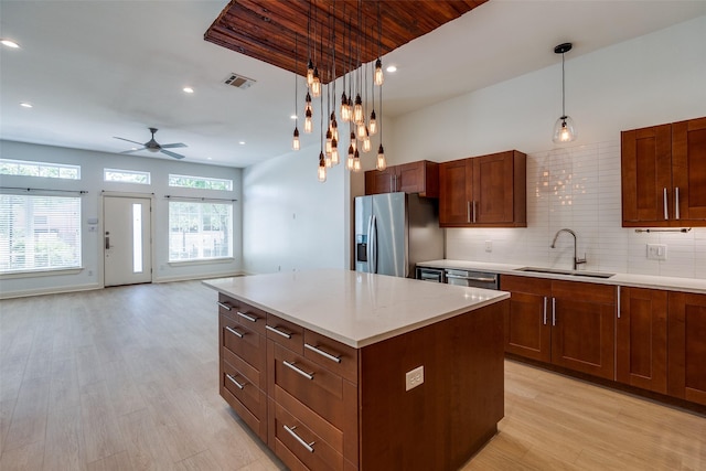 1811 S Ervay St, Dallas, TX 75215 - kitchen with stainless steel appliances, a sink, a ceiling fan, light wood-style flooring, and light countertops