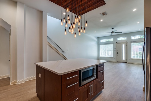 1811 S Ervay St, Dallas, TX 75215 - kitchen featuring appliances with stainless steel finishes, a ceiling fan, light wood-style floors, recessed lighting, and hanging light fixtures