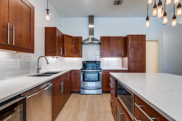1811 S Ervay St, Dallas, TX 75215 - kitchen with wall chimney range hood, appliances with stainless steel finishes, a sink, wine cooler, and light wood-style floors